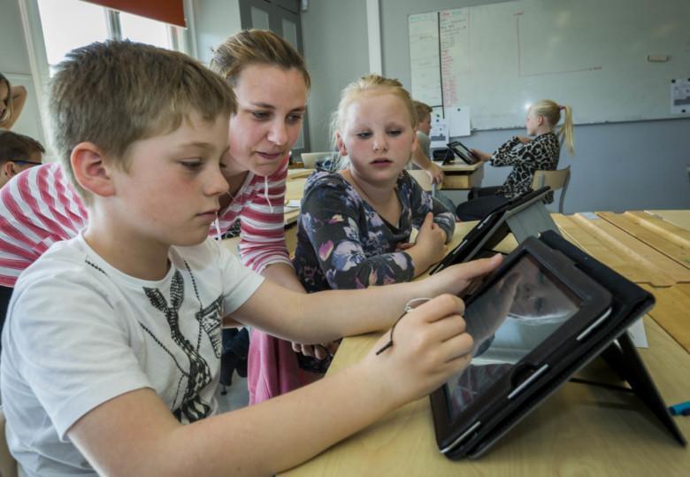 Lapsia koululuokassa käyttämässä iPadia.